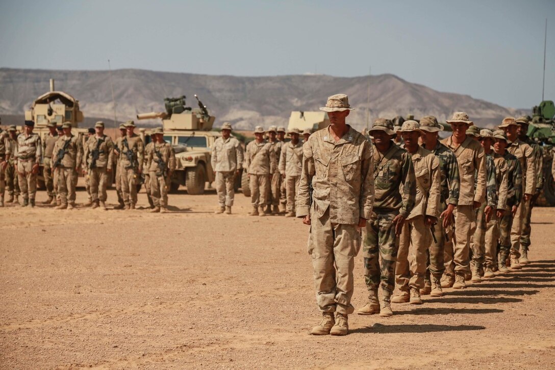 ARTA TRAINING RANGE, Djibouti (Oct. 7, 2015) U.S. Marines with the 15th Marine Expeditionary Unit and soldiers with the French 5th Overseas Combined Arms Regiment (RIAOM) march front and center for distinguished performance during the desert survival and tactics course pinning ceremony. Elements of the 15th MEU trained with the 5th RIAOM in Djibouti from Sept. 21 to Oct. 7 in order to improve interoperability between the MEU and the French military. (U.S. Marine Corps photo by Sgt. Steve H. Lopez/Released)