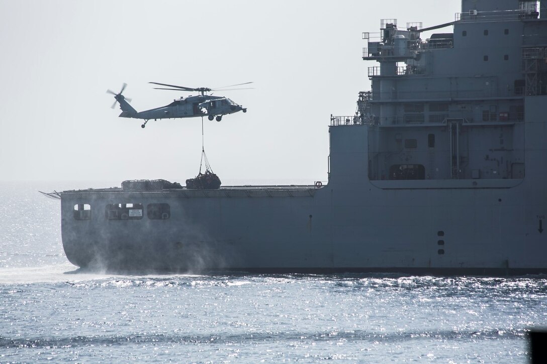 ARABIAN GULF (Oct. 7, 2015) An MH-60S Sea Hawk picks up pallets from the USNS Patuxent (T-AO 201) to transport to the amphibious assault ship USS Essex (LHD 2) during a replenishment-at-sea. U.S. Marines with the 15th Marine Expeditionary Unit and Sailors with the Essex Amphibious Ready Group worked together to distribute the supplies throughout the ship. The 15th MEU, embarked aboard the ships of the Essex ARG, is deployed to maintain regional security in the U.S. 5th Fleet area of operations. (U.S. Marine Corps photo by Cpl. Anna Albrecht/Released)