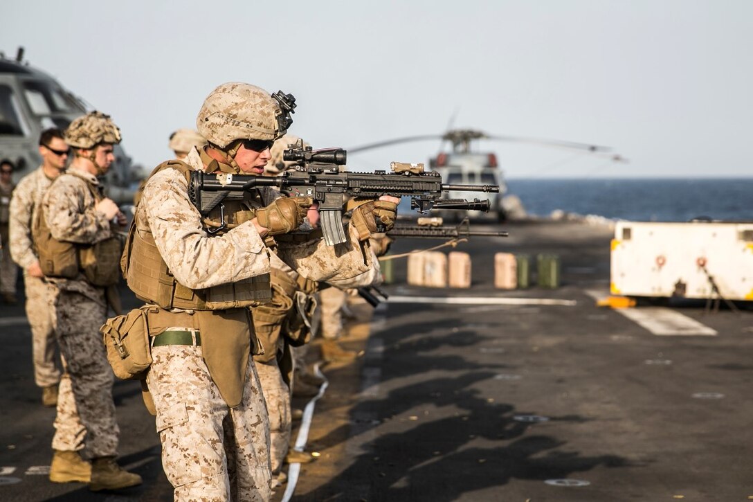 ARABIAN GULF (Oct. 10, 2015) U.S. Marines with Lima Company, Battalion Landing Team 3rd Battalion, 1st Marine Regiment, 15th Marine Expeditionary Unit, aim at their targets during a deck shoot aboard the amphibious assault ship USS Essex (LHD 2). The Marines ran and grappled between their shooting to raise their heart rate and practice shooting while their bodies were fatigued. The 15th MEU, embarked aboard the ships of the Essex ARG, is deployed to maintain regional security in the U.S. 5th Fleet area of operations. (U.S. Marine Corps photo by Cpl. Anna Albrecht/Released)