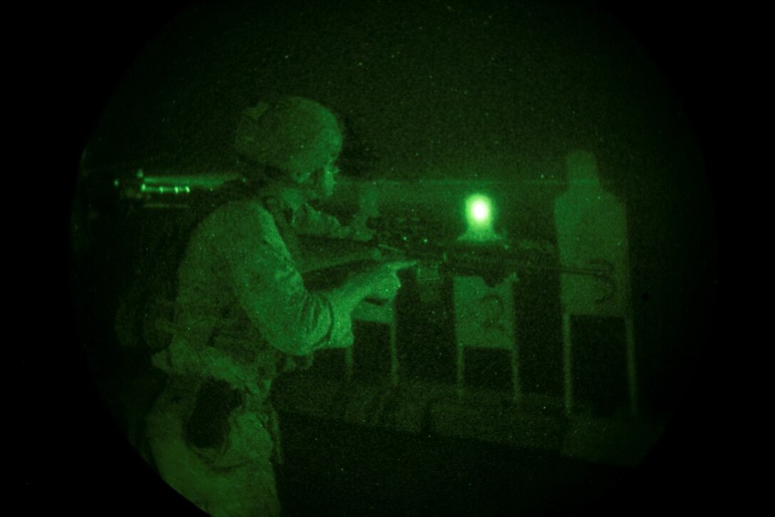 ARABIAN GULF (Oct. 11, 2015) A U.S. Marine with the 15th Marine Expeditionary Unit’s Maritime Raid Force views his target during a deck shoot aboard the amphibious assault ship USS Essex (LHD 2). These Marines practiced shooting at night to enhance their speed and accuracy while shooting in low-light conditions. The 15th MEU, embarked aboard the ships of the Essex ARG, is deployed to maintain regional security in the U.S. 5th Fleet area of operations. (U.S. Marine Corps photo by Cpl. Anna Albrecht/Released)