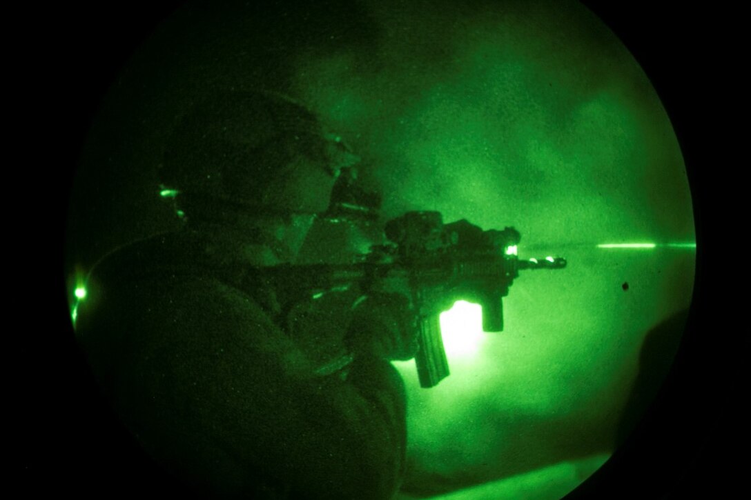 ARABIAN GULF (Oct. 11, 2015) U.S. Marine Cpl. Matthew Jensen fires at his target during a deck shoot aboard the amphibious assault ship USS Essex (LHD 2). Jensen is a member of the 15th Marine Expeditionary Unit’s Maritime Raid Force. These Marines practiced shooting at night to enhance their speed and accuracy while shooting in low-light conditions. The 15th MEU, embarked aboard the ships of the Essex ARG, is deployed to maintain regional security in the U.S. 5th Fleet area of operations. (U.S. Marine Corps photo by Cpl. Anna Albrecht/Released)