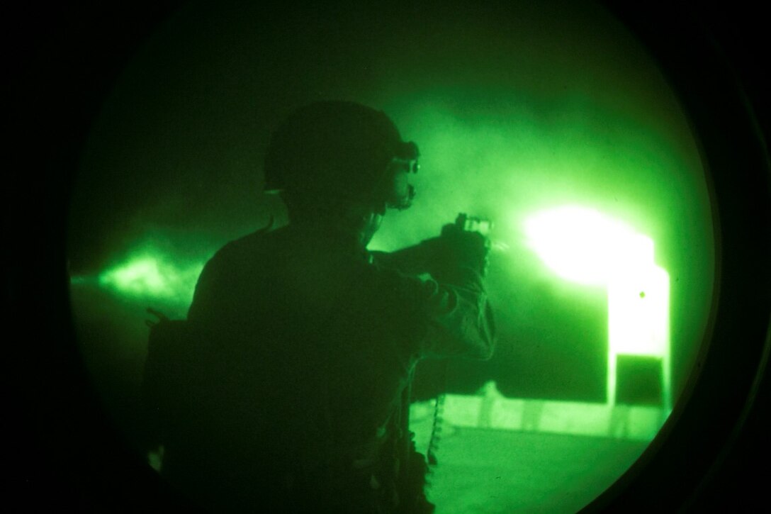 ARABIAN GULF (Oct. 10, 2015) U.S. Marine Cpl. Matthew Jensen fires at his target during a deck shoot aboard the amphibious assault ship USS Essex (LHD 2). Jensen is a member of the 15th Marine Expeditionary Unit’s Maritime Raid Force. These Marines practiced shooting at night to enhance their speed and accuracy while shooting in low-light conditions. The 15th MEU, embarked aboard the ships of the Essex ARG, is deployed to maintain regional security in the U.S. 5th Fleet area of operations. (U.S. Marine Corps photo by Cpl. Anna Albrecht/Released)