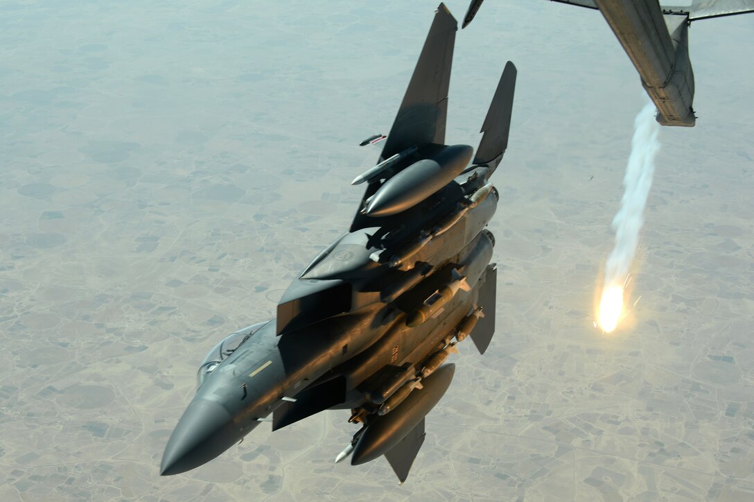 An Air Force F-15E Strike Eagle pops a flare while departing after refueling with a KC-10 Extender tanker over Southwest Asia in support of Operation Inherent Resolve, Aug. 30, 2015. Air Force photo by Staff Sgt. Sandra Welch