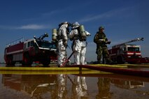 Firefighters from the 8th Civil Engineer Squadron communicate with each other while participating in an aircraft fire exercise during Beverly Pack 16-1 at Kunsan Air Base, Republic of Korea, Oct. 07, 2015. The aircraft fire is one of the many exercises that the firefighters participate in as a refresher training to sharpen their skills in the case of a real world emergency. (U.S. Air Force photo by Senior Airman Ashley L. Gardner/Released)
