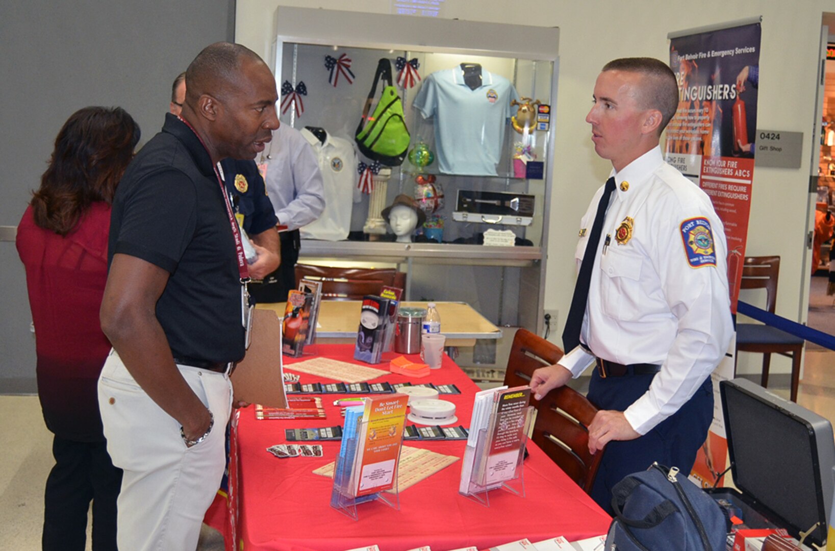 A McNamara Headquarters Complex employee talks with a member of the Fort Belvoir Fire Department Sept. 16 at the Preparedness and Security Expo. The expo featured various vendors, demonstrations and information to help employees better prepare for emergencies.