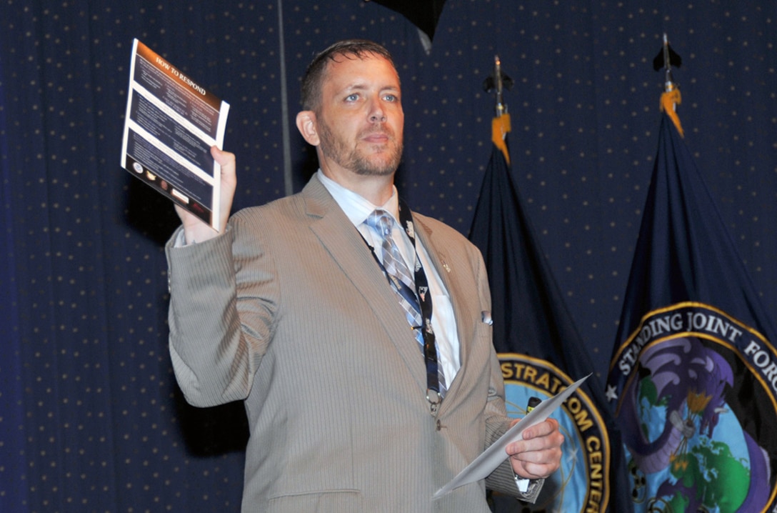 James Johnston, an anti-terrorism officer in Defense Logistics Agency Installation Support, holds up a Department of Homeland Security guide on active shooters during a National Preparedness Month seminar Sept. 15 at the McNamara Headquarters Complex. 