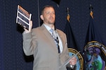 James Johnston, an anti-terrorism officer in Defense Logistics Agency Installation Support, holds up a Department of Homeland Security guide on active shooters during a National Preparedness Month seminar Sept. 15 at the McNamara Headquarters Complex. 