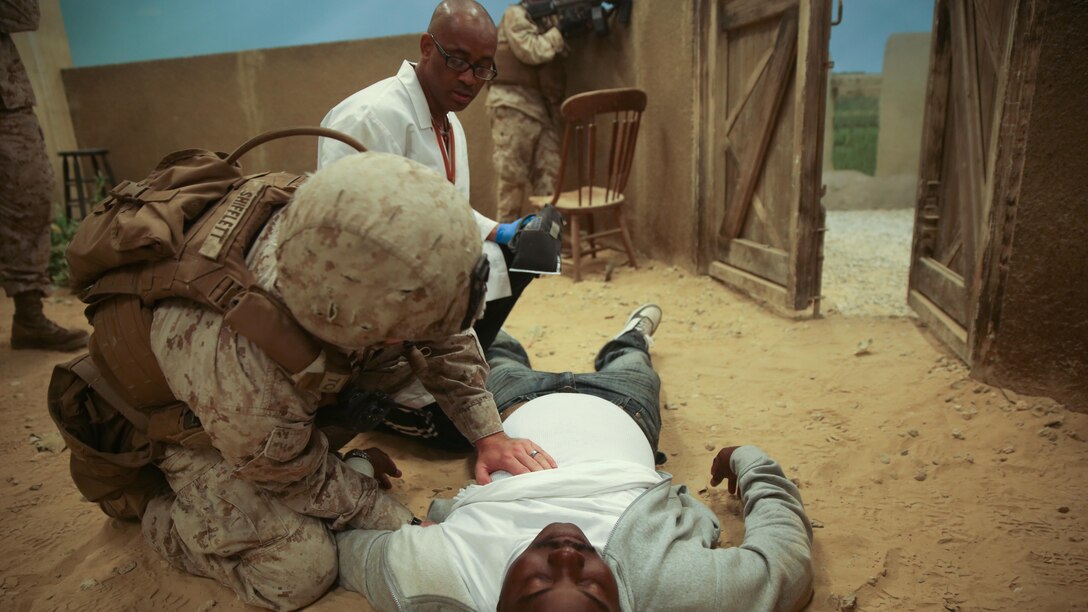 Cpl. Willis Shifflett, a squad leader with 2nd Combat Engineer Battalion, performs first-aid on a simulated civilian casualty during the Infantry Immersion Trainer at Camp Lejeune, N.C., Oct. 9, 2015. The IIT is used to allow Marines to put themselves into a deployment scenario and take constructive criticism after their mission is completed. 