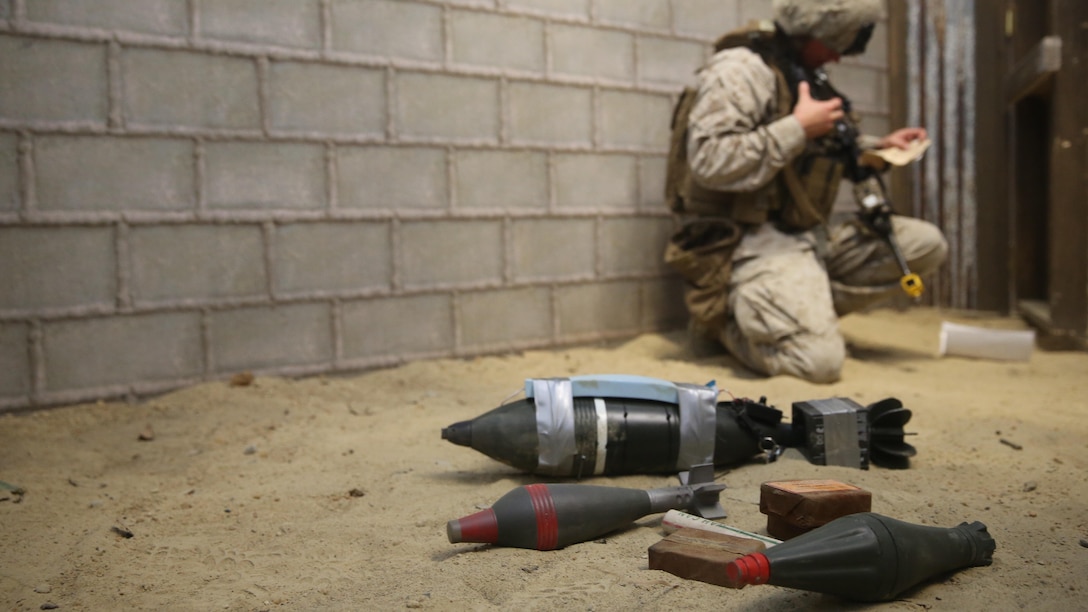Cpl. Willis Shifflett, a squad leader with 2nd Combat Engineer Battalion, radios his platoon commander after finding a cache of possible simulated improvised explosive devices during the Infantry Immersion Trainer at Camp Lejeune, N.C., Oct. 9, 2015.The IIT is used to allow Marines to put themselves into a deployment scenario and take constructive criticism after their mission is completed. 