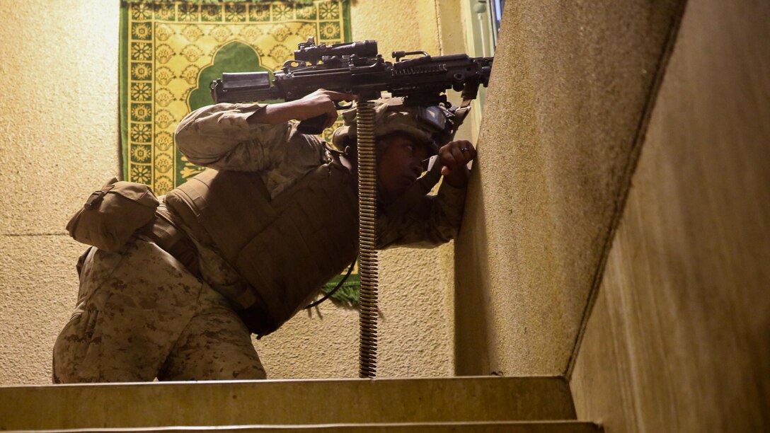 Lance Cpl. Lance J. Daniel, a Marine with the 2nd Combat Engineer Battalion, maintains security in a building during the Infantry Immersion Trainer at Camp Lejeune, N.C., Oct. 9, 2015.The IIT is used to allow Marines to put themselves into a deployment scenario and take constructive criticism after their mission is completed. 