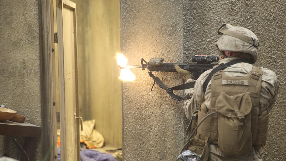 Pfc. Ethan Lousberg, a Marine with the 2nd Combat Engineer Battalion, fires at a simulated enemy combatant during the Infantry Immersion Trainer at Camp Lejeune, N.C., Oct. 9, 2015.The IIT is used to allow Marines to put themselves into a deployment scenario and take constructive criticism after their mission is completed. 