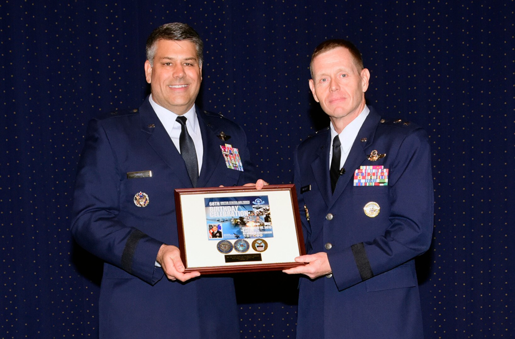 Air Force Brig. Gen. Gregory Otey, director of the Nuclear Enterprise Support Directorate at the Defense Threat Reduction Agency, presents a token of appreciation to guest speaker Air Force Maj. Gen. Robert Wheeler following the 68th birthday celebration of the Air Force Sept. 10 at McNamara Headquarters Complex.