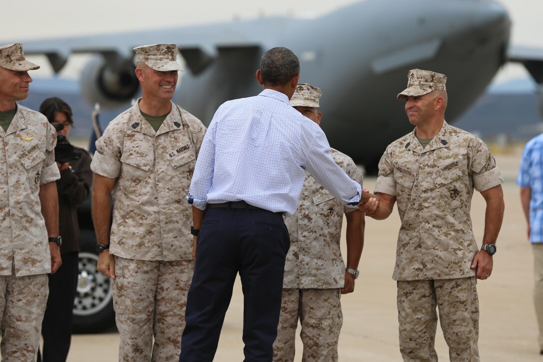 President Barack Obama greets Sgt. Maj. Richard Charon, sergeant major of Marine Corps Air Station Miramar, aboard MCAS Miramar, Calif., Oct. 12. The president paid a quick visit to the air station before boarding Air Force One, the presidential plane.