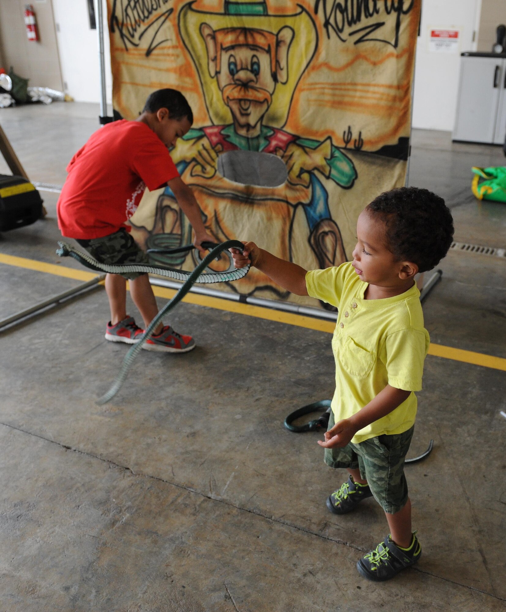 Cedric and Isaiah Johnson, sons of Staff Sgt. Chris Johnson, 335th Training Squadron precision measurement equipment laboratory instructor, play games during the Keesler Fire Department open house at the fire station Oct. 10, 2015, Keesler Air Force Base, Miss. The open house was the conclusion event to Fire Prevention Week. Throughout the week the Keesler Fire Department conducted random fire drills, toured various facilities with Sparky the Fire Dog, passed out fire safety information and fire hats for children and provided stove and fire extinguisher demonstrations. (U.S. Air Force photo by Kemberly Groue)