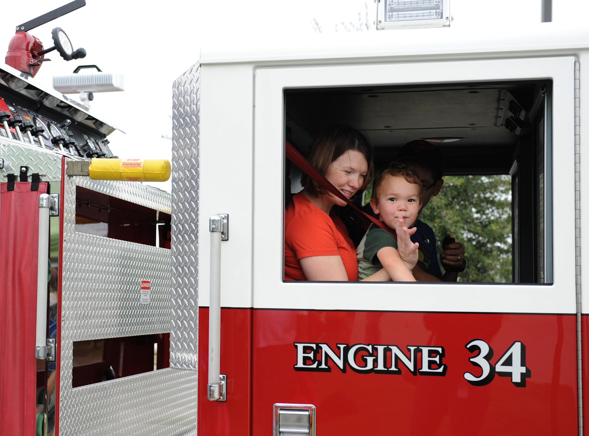 Tech. Sgt. Victoria Cortez, 81st Diagnostic and Therapeutics Squadron mammography NCO in charge, and her son, Alexander, take a fire truck ride during the Keesler Fire Department open house at the fire station Oct. 10, 2015, Keesler Air Force Base, Miss. The open house was the conclusion event to Fire Prevention Week. Throughout the week the Keesler Fire Department conducted random fire drills, toured various facilities with Sparky the Fire Dog, passed out fire safety information and fire hats for children and provided stove and fire extinguisher demonstrations. (U.S. Air Force photo by Kemberly Groue)