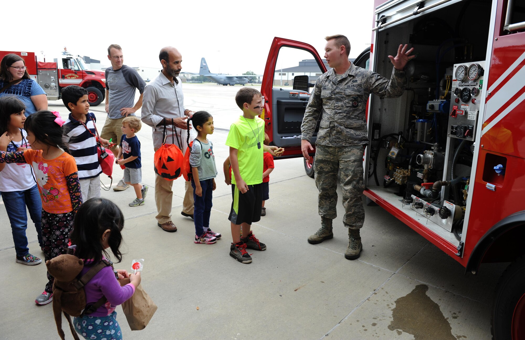 Senior Airman Seth Corn, 81st Infrastructure Division driver and operator, provides a tour of a fire truck during the Keesler Fire Department open house at the fire station Oct. 10, 2015, Keesler Air Force Base, Miss. The open house was the conclusion event to Fire Prevention Week. Throughout fire prevention week the Keesler Fire Department conducted random fire drills, toured various facilities with Sparky the Fire Dog, passed out fire safety information and fire hats for children and provided stove and fire extinguisher demonstrations. (U.S. Air Force photo by Kemberly Groue)