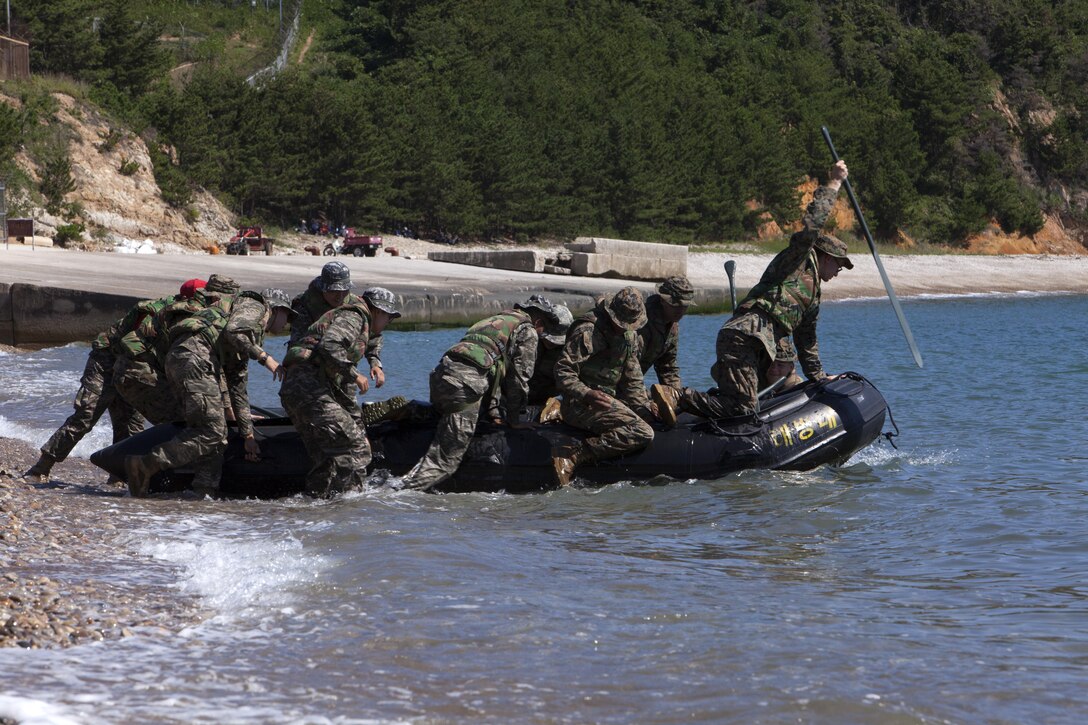 U.S. and Republic of Korea Marines launch an inflatable boat off the coast of Baengnyeongdo, Republic of Korea, during Korean Marine Exchange Program 15-13, Sept. 7, 2015. Marines trained as integrated units carrying, paddling and learning to work as a team. KMEP is a regularly scheduled training event which highlights the invaluable opportunities for ROK and U.S. Marines to train and learn from each other. The U.S. Marines are assigned to 3rd Platoon, Echo Company, 2nd Battalion, 3rd Marine Division, currently attached to 4th Marine Regiment, III Marine Expeditionary Force, through the Unit Deployment Program. The ROK Marines are with 11th Company, 63rd Battalion, 6th Brigade, 1st Regiment, 2nd ROK Marine Corps Division, ROK Headquarters Marine Corps.