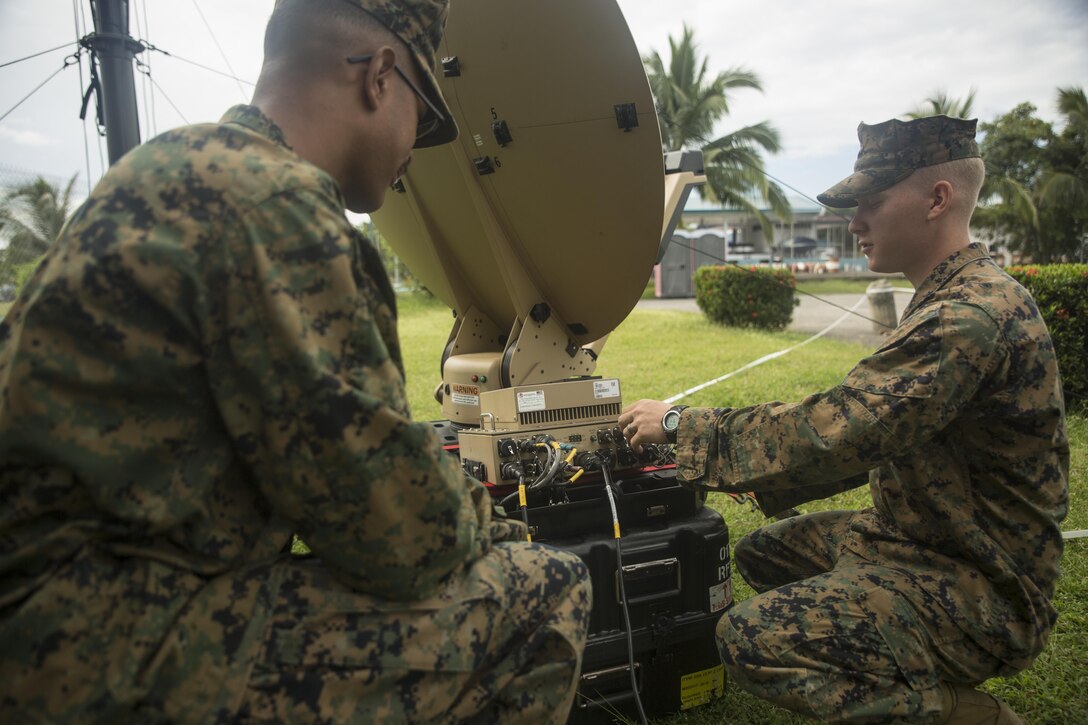 Cpl. Jake Morales, left, and Cpl. Wesley McCulloch troubleshoot a Hawkeye III Lite satellite at Clark Air Base, Philippines, Oct. 6, 2015. Communication Marines are a vital link to the command and provided 3rd Marine Expeditionary Brigade with communications throughout Amphibious Landing Exercise 2015. PHIBLEX 2015 is an annual, bilateral training exercise conducted by U.S. Marine and Navy Forces with the Armed Forces of the Philippines in order to strengthen our interoperability and working relationships across the range of military operations — from disaster relief, to complex expeditionary operations. Morales from Philadelphia, Pennsylvania, is a data network specialist with 7th Communications Battalion, III Marine Headquarters Group, III Marine Expeditionary Force. McCulloch, from Dyersburg, Tennessee, is a field radio operator with 7th Comm Bn., III MHG, III MEF.