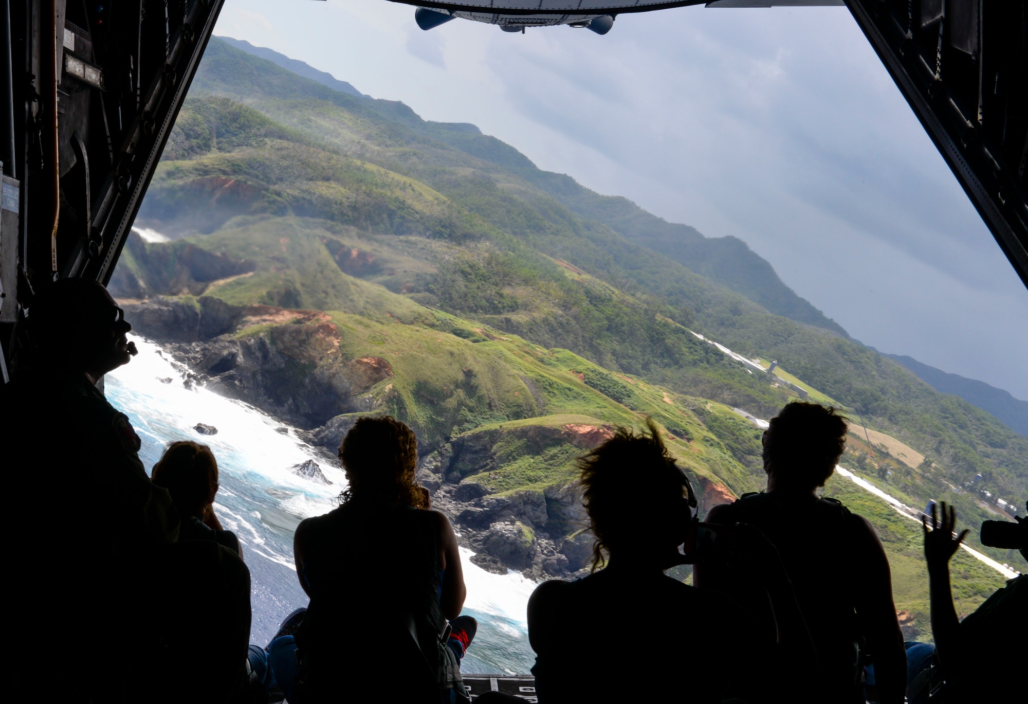 Spouses from the 353rd Special Operations Group look out the back of a MC-130H Combat Talon II during a spouse orientation flight Oct. 8, 2015, off the coast of Okinawa, Japan.  Spouses of special operations Airmen often times spend and extended period of time away from their husbands and wives due to mission requirements. The orientation flight, along with various other activities, gave the spouses and opportunity to have a firsthand look at the group’s daily operations. (U.S. Air Force photo by Senior Airman John Linzmeier)