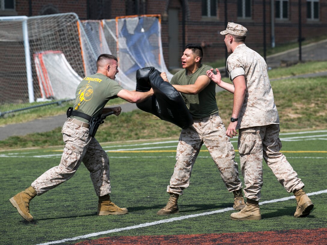 Guard Marines from Marine Barracks Washington, D.C., perform various tasks while incapacitated by oleoresin capsicum spray at the annex field during an OC course evaluation, Oct. 8, 2015. (U.S. Marine Corps photo by Cpl. Christian Varney/Released)