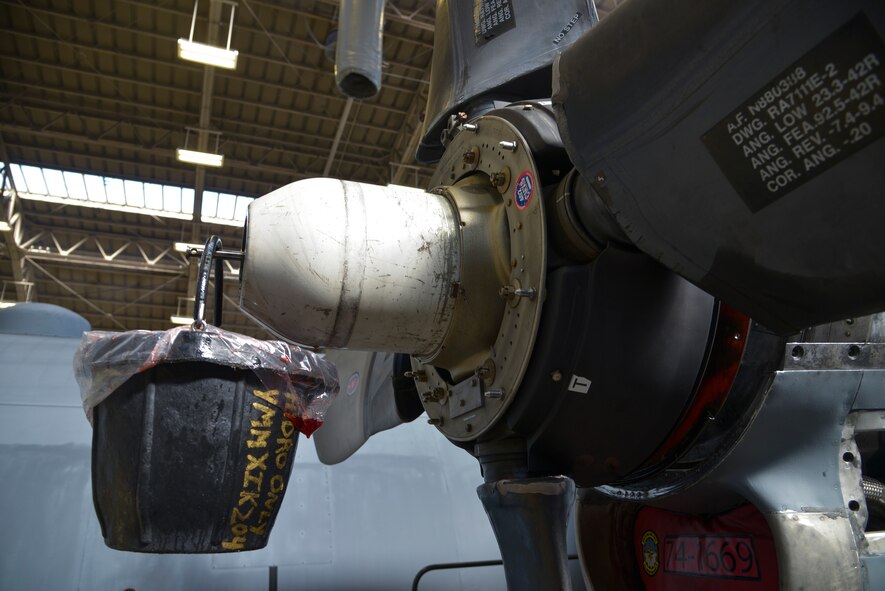 A bucket filled with hydraulic fluid hangs from part of a C-130 Hercules propeller at Yokota Air Base, Japan, Oct. 8, 2015. During the 14-day phase dock process, Airmen inspect the aircraft and fix approximately 1,000 discrepancies. (U.S. Air Force photo by Senior Airman David Owsianka/Released)