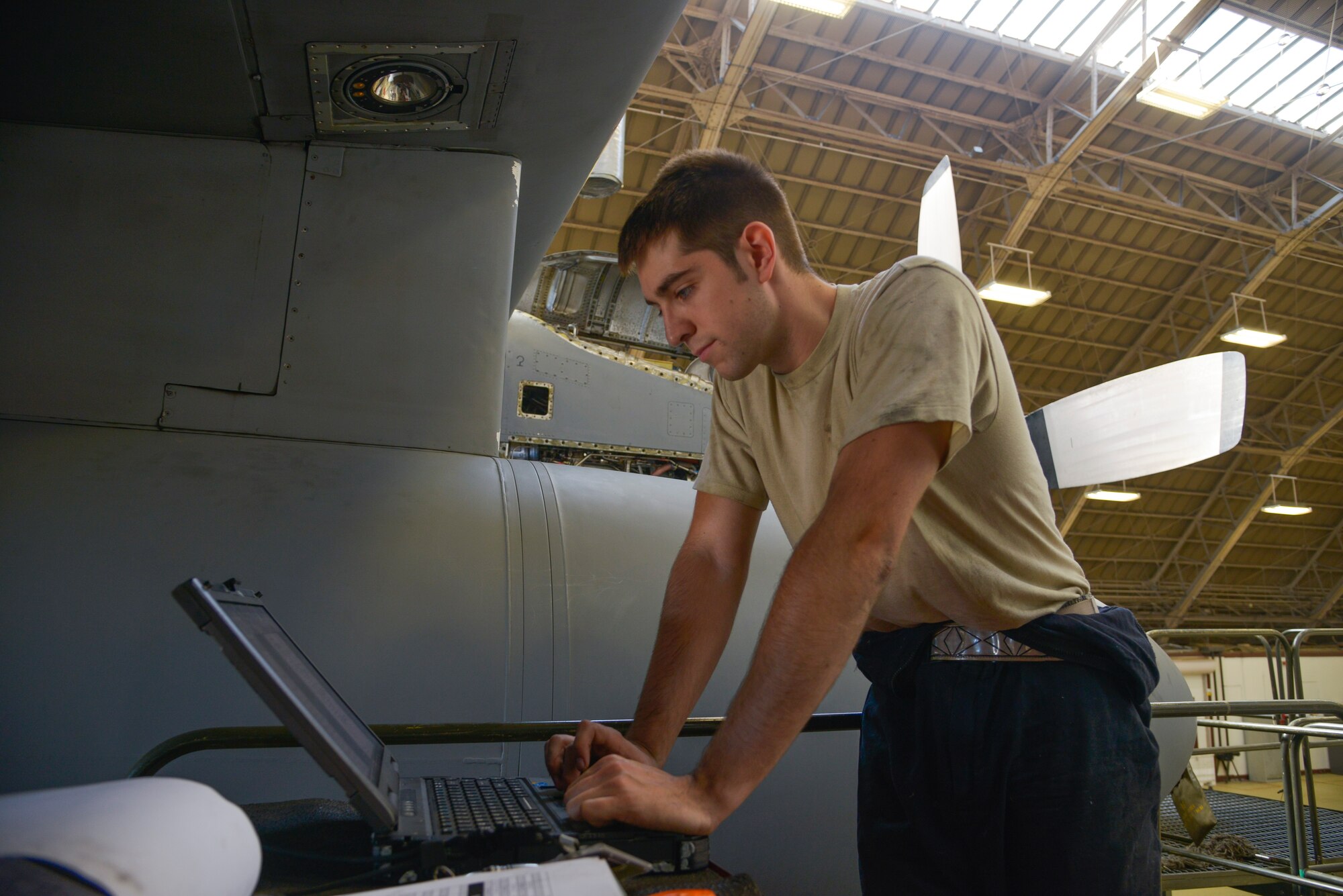 Airman 1st Class Jacob Lay, 374th Maintenance Squadron airspace propulsion journeyman, looks for any discrepancies on the propeller within a maintenance database on the laptop at Yokota Air Base, Japan, Oct. 8, 2015. Inspections are completed much faster during a paperless process, allowing Airmen to utilize multiple computers and tablets while simultaneously conducting the inspection. (U.S. Air Force photo by Senior Airman David Owsianka/Released)