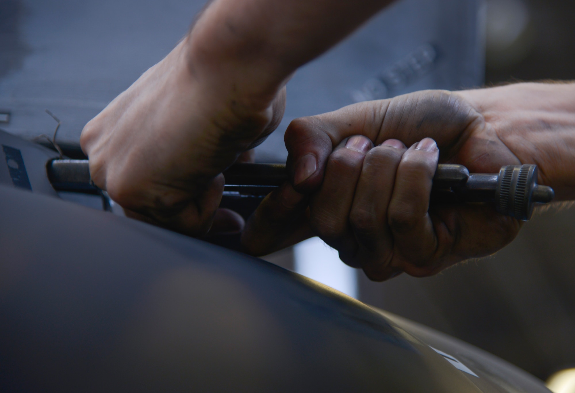 Airman 1st Class Jacob Lay, 374th Maintenance Squadron airspace propulsion journeyman, removes safety wire from a C-130 Hercules propeller for inspection at Yokota Air Base, Japan, Oct. 6, 2015. Phase dock inspections begin with the ‘look phase;’ the aircraft is removed of panels and discrepancies are noted. (U.S. Air Force photo by Senior Airman David Owsianka/Released)