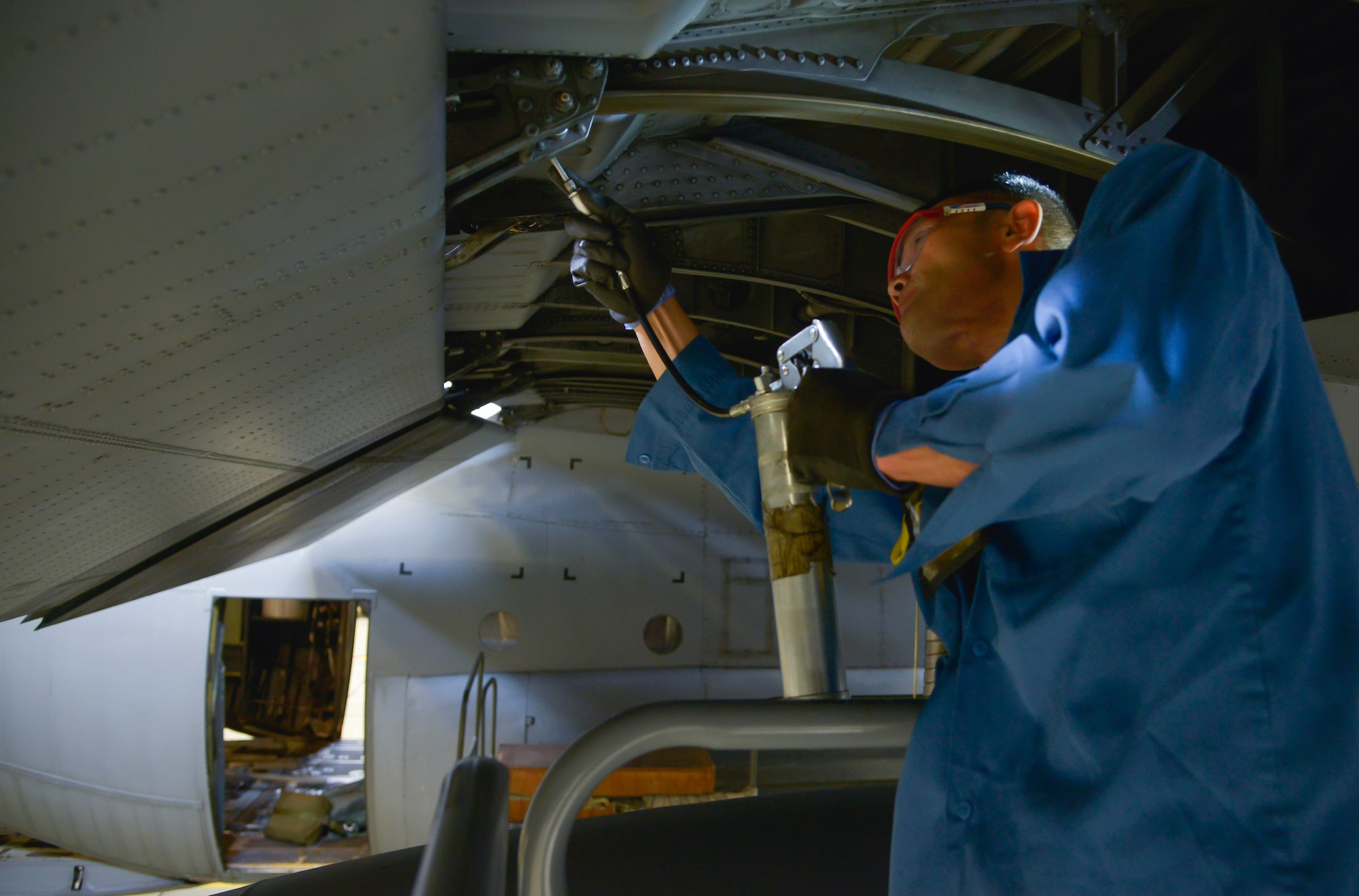 Toshio Shimada, 374th Maintenance Squadron aircraft mechanic, loosens bolts on a panel of a C-130 Hercules at Yokota Air Base, Japan, Oct. 6, 2015. Every 540 days a C-130 Hercules enters the phase docks for an isochronal inspection. (U.S. Air Force photo by Senior Airman David Owsianka/Released)