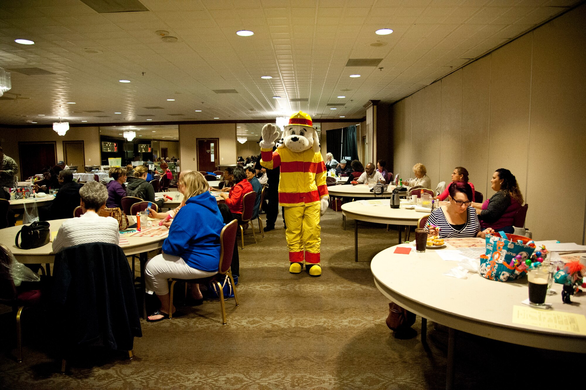 PETERSON AIR FORCE BASE, Colo. – Sparky, the fire dog, visits with The Club’s Bingo attendees during Fire Prevention Week, Oct. 5, 2015. Sparky is making visits to Terra Vista residents, schools and the child development centers to help educate the importance of fire safety to Team Pete and their families. (U.S. Air Force photo by Senior Airman Tiffany DeNault)