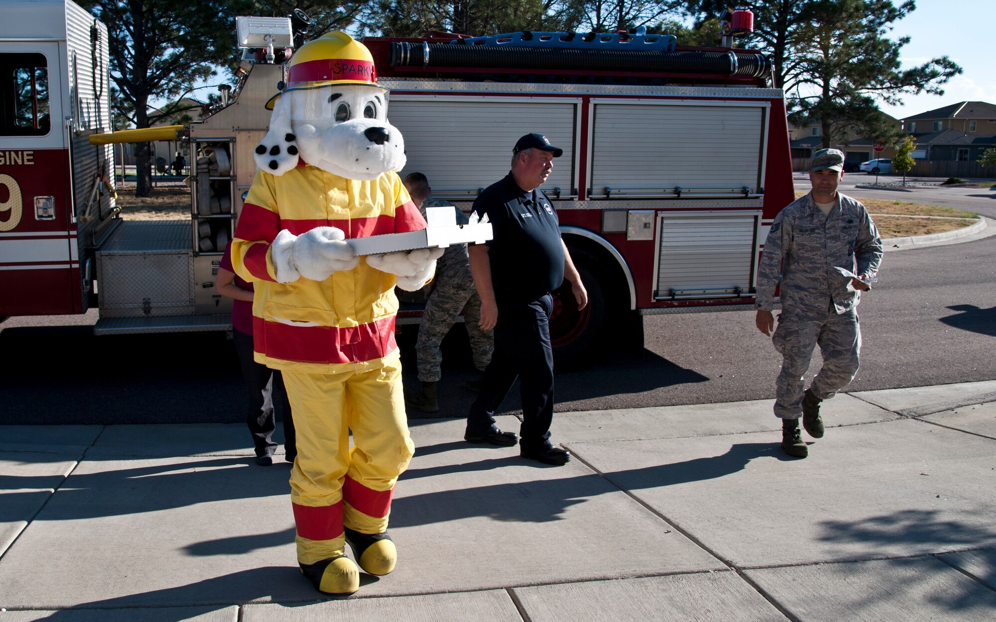 PETERSON AIR FORCE BASE, Colo. – Sparky, the fire dog, and Airmen from the 21st Civil Engineering Squadron fire station, visits Terra Vista residents to check their smoke alarms, Oct. 5, 2015. As part of Fire Prevention Week, the fire station is partnering with Terra Vista and the Colorado Pizza Company on Oct. 5, 6 and 9 from 4-8 p.m. to check Terra Vista residents’ smoke alarms. (U.S. Air Force photo by Senior Airman Tiffany DeNault)
