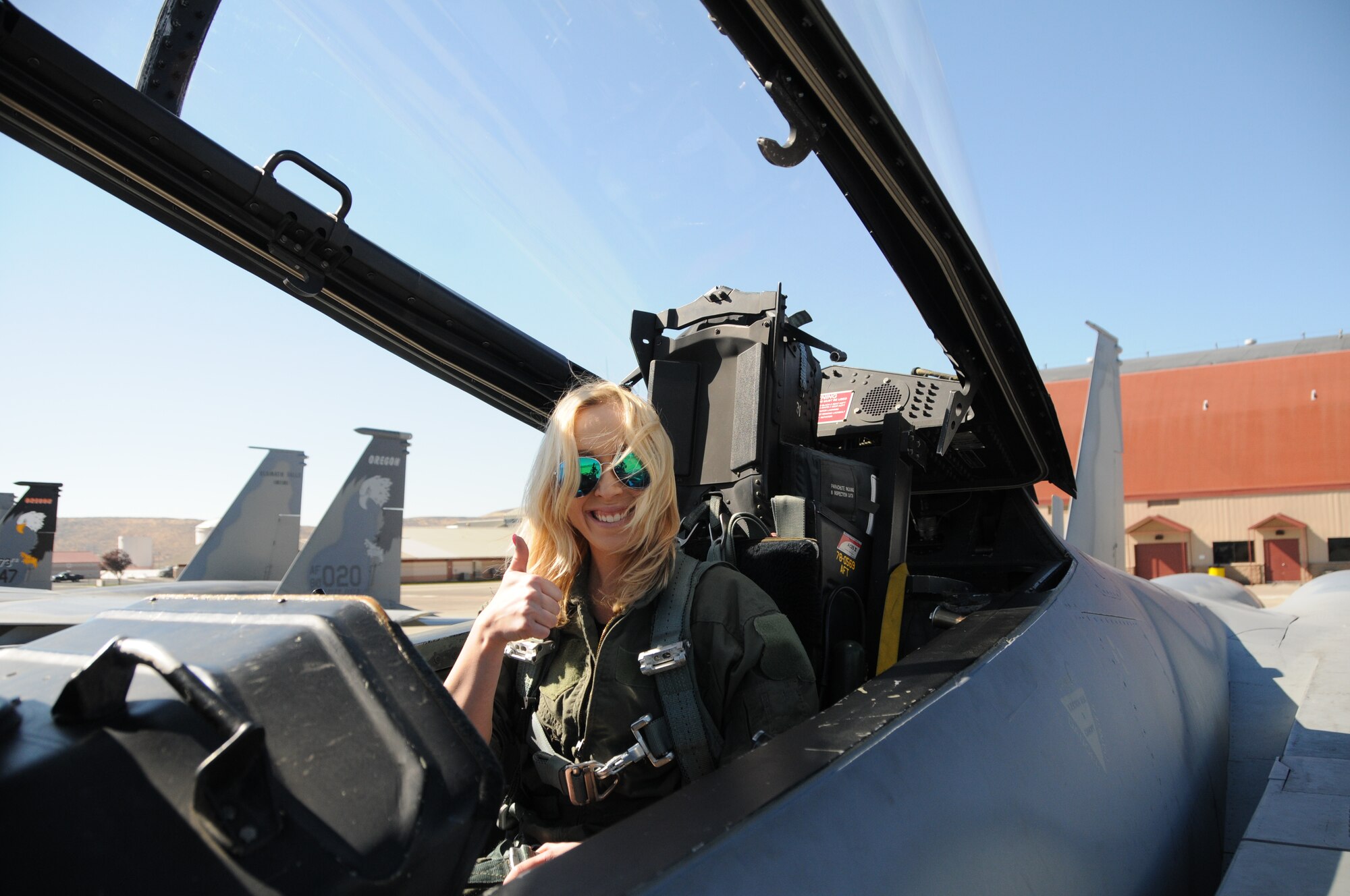 One of the spouses of a 173rd Fighter Wing maintainer gives a thumbs up as she straps into an F-15C in preparation for a high speed  taxi ride arranged for spouses of maintenance group members, Oct. 4, 2015 at Kingsley Field, Ore.. During the morning 20 spouses saw first-hand the result of their significant others’ work on a day-to-day basis. (U.S. Air National Guard photo by Tech. Sgt. Jefferson Thompson/released)