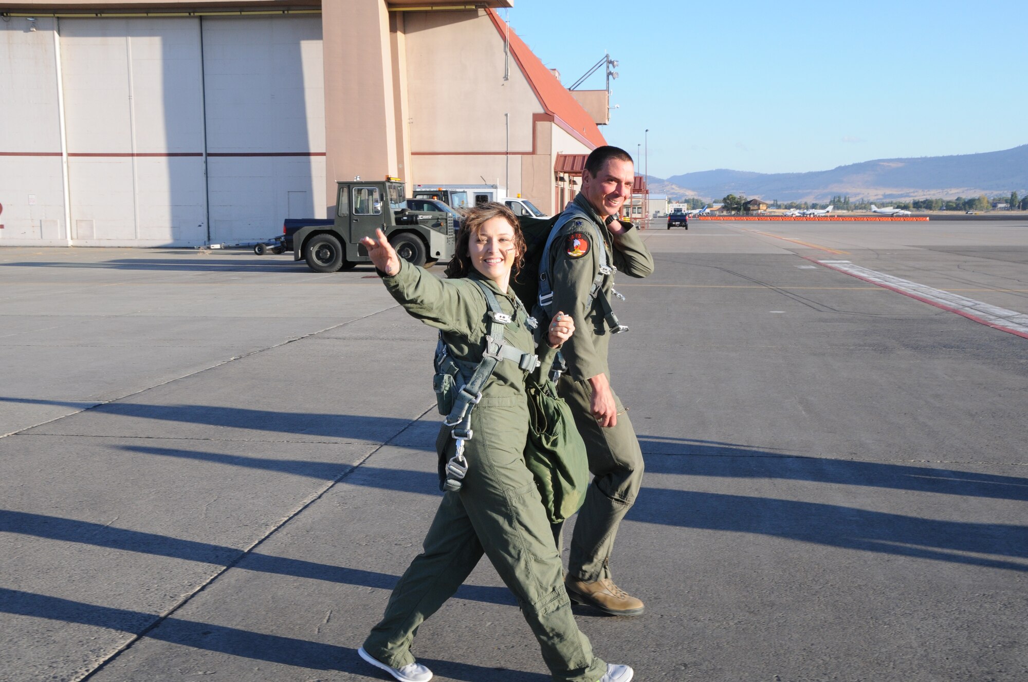 One of the spouses of a 173rd Fighter Wing maintainer waves at her family while stepping to the F-15C with pilot Lt. Col. Jeremy Wieder, 173rd Maintenance Squadron commander,  in preparation for a taxi ride arranged for spouses of maintenance group members, Oct. 4, 2015. During the morning 20 spouses saw first-hand the result of their significant others’ work on a day-to-day basis. (U.S. Air National Guard photo by Tech. Sgt. Jefferson Thompson/released)