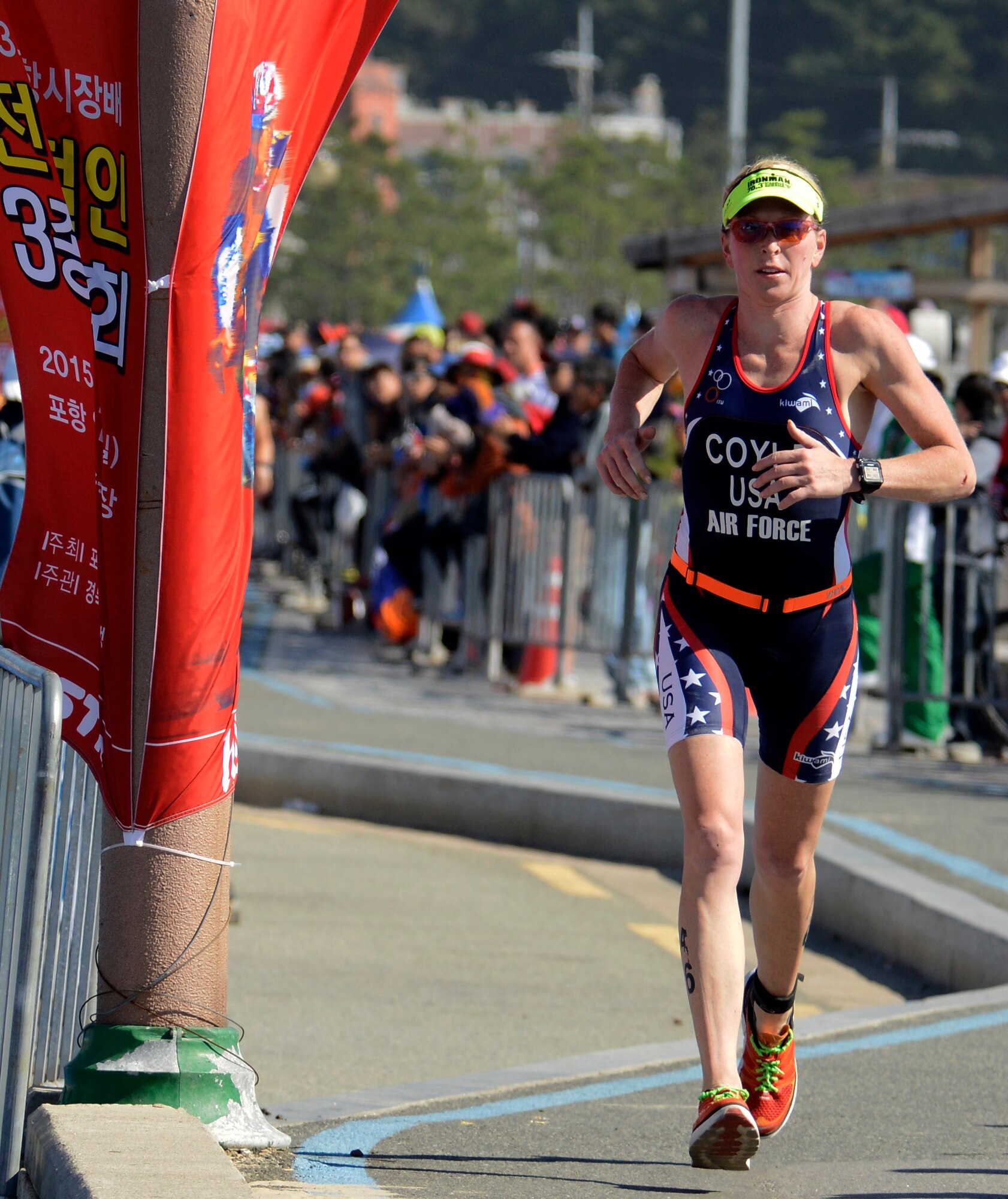 U.S. Air Force Maj. Judith Coyle, 728th Airlift Squadron pilot out of  Joint Base Lewis-McChord, Washington, runs the last leg of the women's triathlon in downtown Pohang, South Korea, during the CISM World Games Oct. 10, 2015. Coyle earned bronze for the USA with an overall time of two hours, 15 minutes and 27.69 seconds in the triathlon. (U.S. Armed Forces Sports photo by Gary Sheftick)