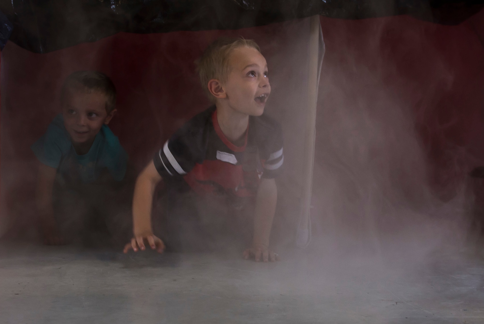 Children navigate through a smoke maze during the National Fire Prevention Week open house at Fire Station 1 Oct. 7, 2015 on Mountain Home Air Force Base, Idaho. The smoke maze gives a better understanding on what it's like to escape during a house fire. (U.S. Air Force photo by Airman Chester Mientkiewicz)