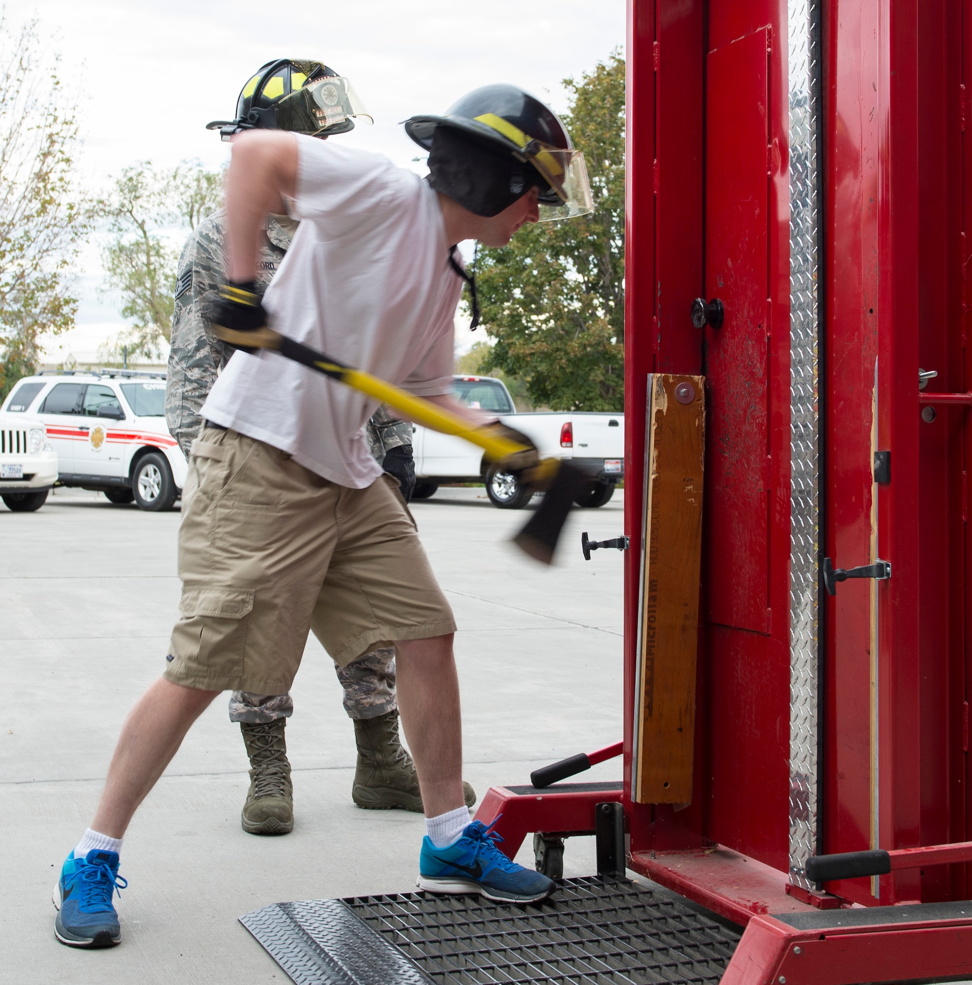 A participant attempts to open a door during an open house at Fire Station 1 Oct. 7, 2015 at Mountain Home Air Force Base, Idaho. The exercise teaches people the amount of force needed to open the door during a fire along with the correct ways to open a door. (U.S. Air Force photo by Airman Chester Mientkiewicz)