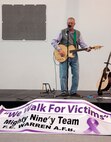 Mark Warner, 90th Missile Wing Protocol office, plays an original song, “Blink of an Eye,” during a domestic violence rally Oct. 9, 2015, in the Fall Hall Community Center on F.E. Warren Air Force Base, Wyo. Warner wrote the song after dealing with a personal experience with domestic violence. (U.S. Air Force photo by Senior Airman Brandon Valle)