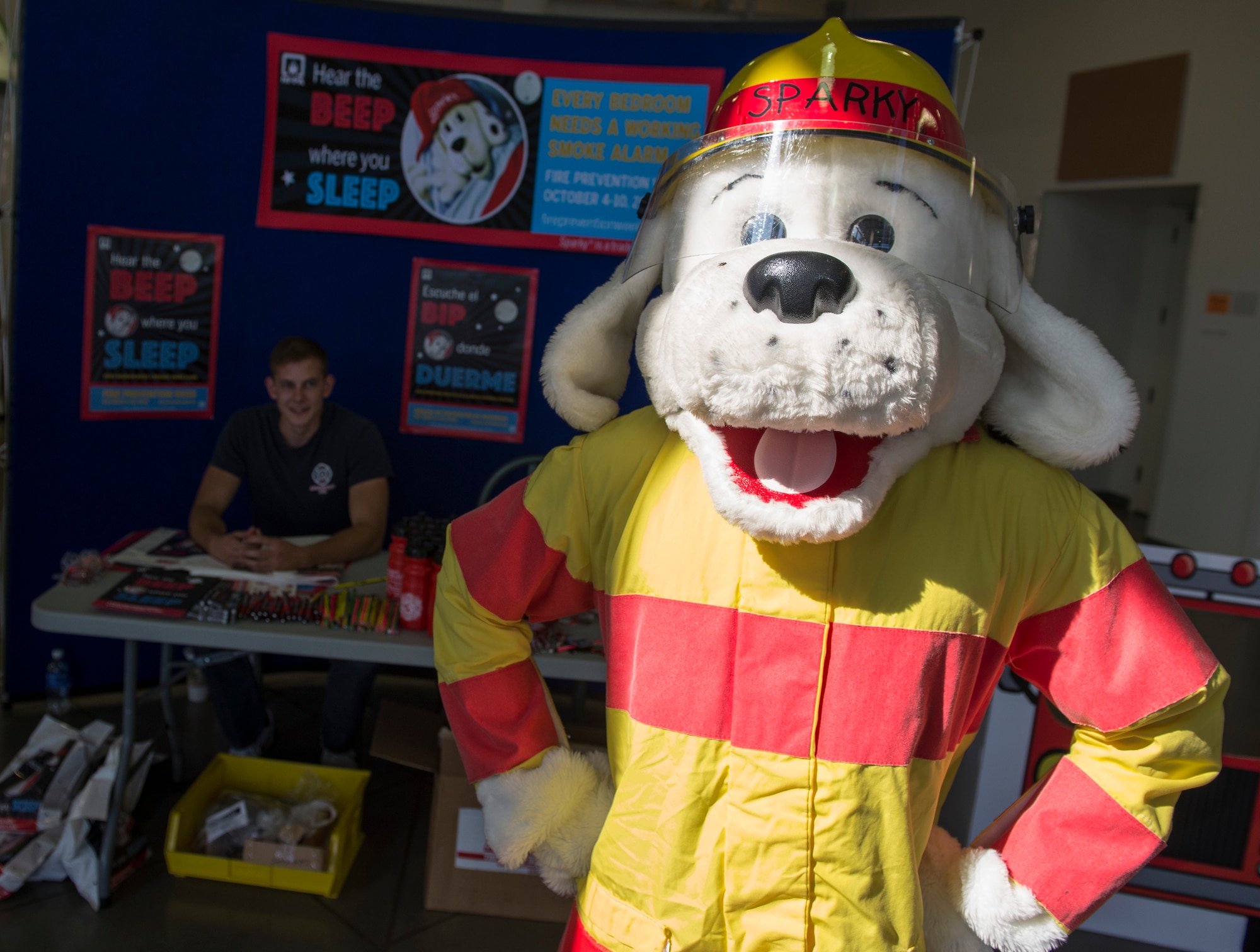 Sparky the Dog stands in front of a display booth in the Base Exchange Oct. 6, 2015 at Mountain Home Air Force Base, Idaho.  His mission is teaching youth fire safety. (U.S. Air Force photo by Airman Chester Mientkiewicz)