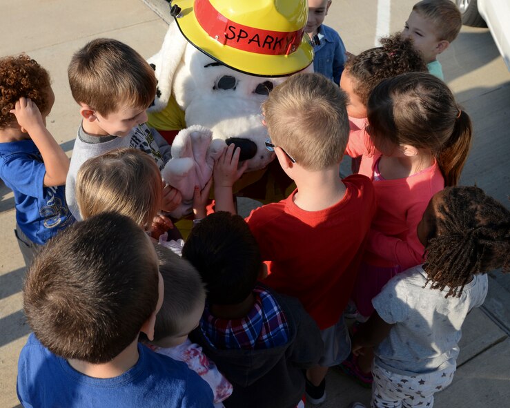 Sparky the Fire Dog visits children during National Fire Prevention Week at the Child Development Center on Barksdale Air Force Base, La., Oct. 7, 2015. Sparky visited the CDC, youth center and gate entrances to bring awareness of fire safety. (U.S. Air Force photo/Senior Airman Jannelle Dickey)