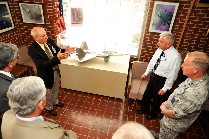 Dr. C. David Brown, the deputy assistant secretary of defense for Developmental Test and Evaluation and the director of the Test Resource Management Center, pictured at left center, and Major Gen. David A. Harris, commander of the Air Force Test Center, far right, recently visited AEDC. While on base they took a tour of the Propulsion Wind Tunnel (PWT) Facility. Pictured here in the PWT lobby, Dr. Brown speaks with Ed Mickle (second from right), senior manager of AEDC Aerodynamics Test Facility Planning, about the capabilities of the wind tunnels. (Photo by Rick Goodfriend)