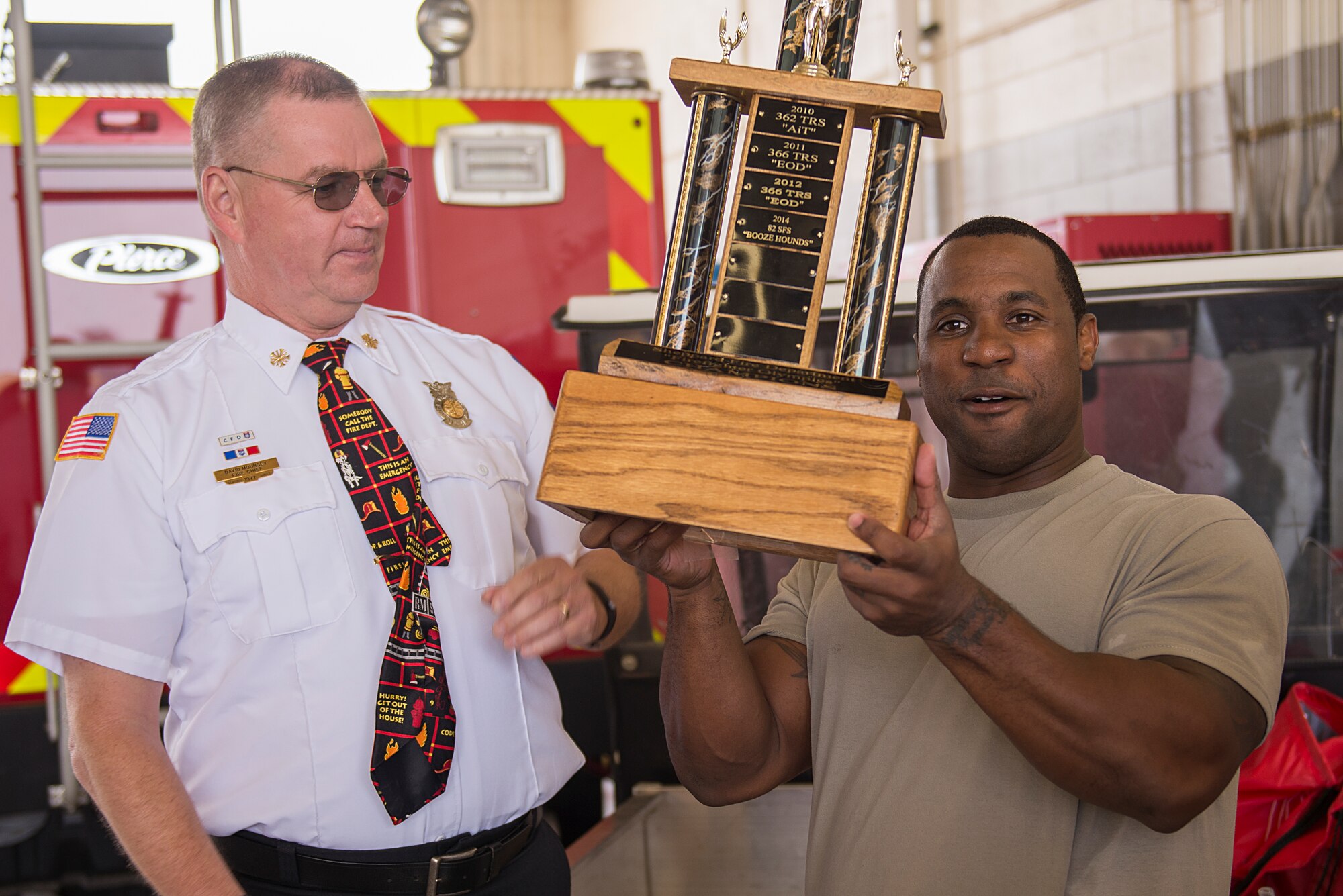 Tech. Sgt. Marcus Levias, 80th Operations Support Squadron air traffic controller, holds the first place trophy after his team won the 6th Annual Firefighter Olympic Challenge at Sheppard Air Force Base, Texas, Oct. 9, 2015. The challenge took place during fire prevention week as a means to raise awareness for fire safety and prevention. (U.S. Air Force photo/Senior Airman Kyle Gese)