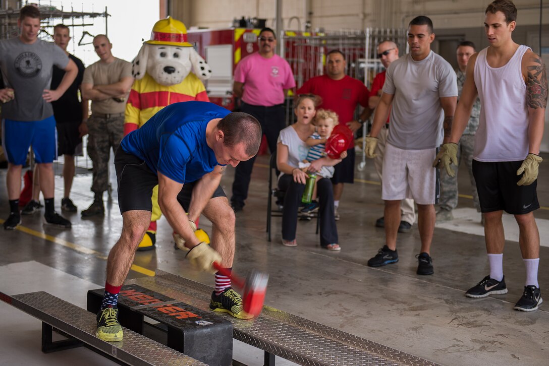Senior Airman Ethan Benson, 80th Operations Support Squadron air traffic controller, participates in the Keiser sled drill during the 6th Annual Firefighter Olympic Challenge at Sheppard Air Force Base, Texas, Oct. 9. 2015. The challenge took place during fire prevention week as a means to raise awareness for fire safety and prevention. (U.S. Air Force photo/Senior Airman Kyle Gese)