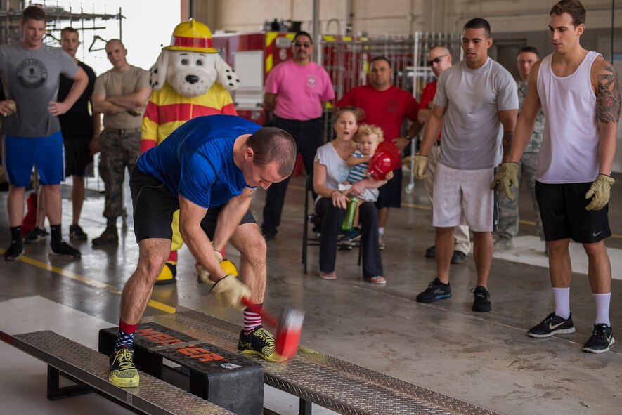 Senior Airman Ethan Benson, 80th Operations Support Squadron air traffic controller, participates in the Keiser sled drill during the 6th Annual Firefighter Olympic Challenge at Sheppard Air Force Base, Texas, Oct. 9. 2015. The challenge took place during fire prevention week as a means to raise awareness for fire safety and prevention. (U.S. Air Force photo/Senior Airman Kyle Gese)