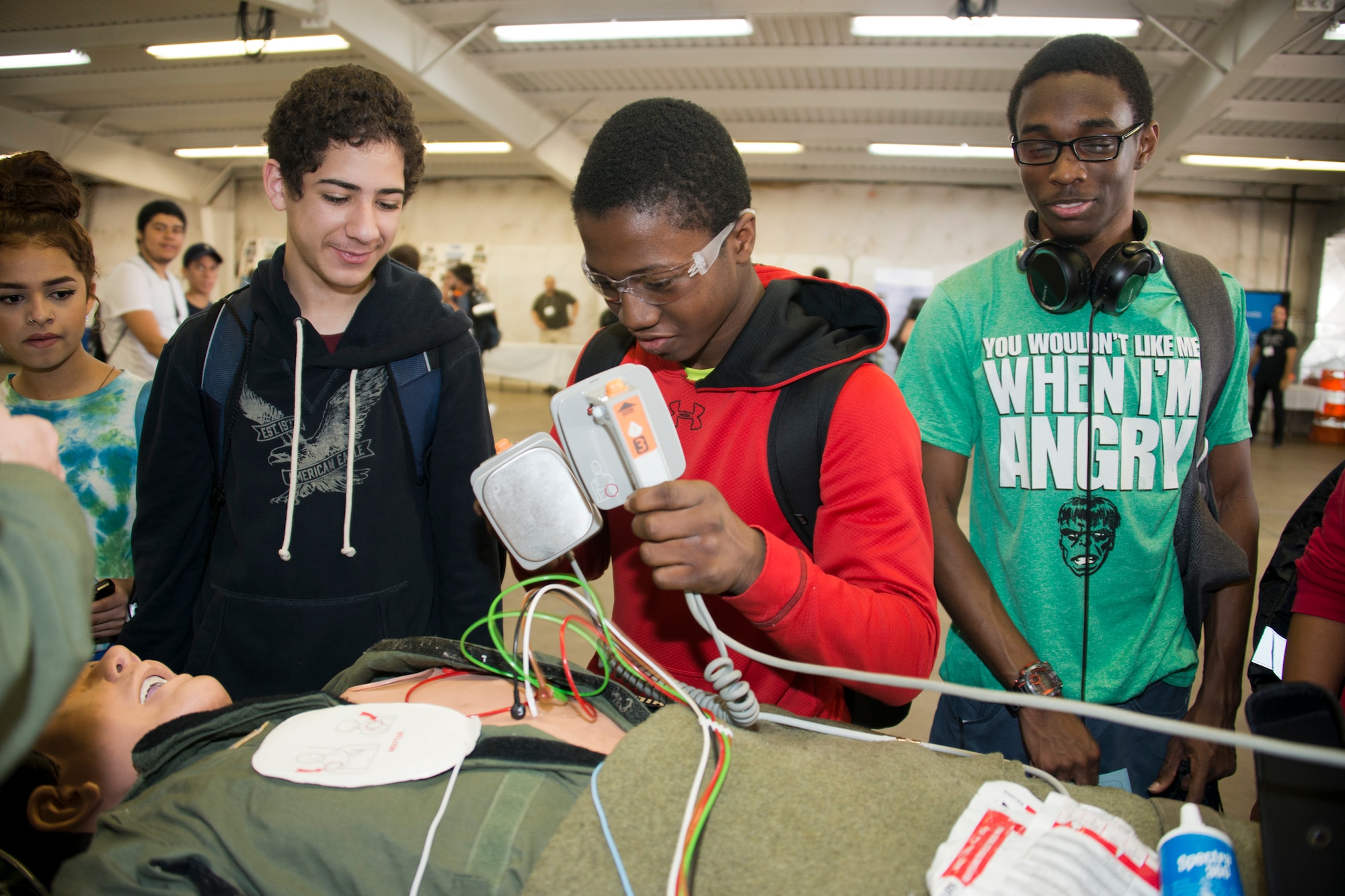 Students experiment with a HeartStart defibrillator on a medical mannequin at the Virginia Department of Transportation Career Fair at Prince William County Fairgrounds Oct. 8, 2015. The event, which drew more than 1,300 students from the Prince William County area, provided an opportunity for youths to learn about careers in the transportation industry. The 459th was on hand to discuss potential career paths as pilots, boom operators and inflight medics. (U.S. Air Force photo by Staff Sgt. Kat Justen)