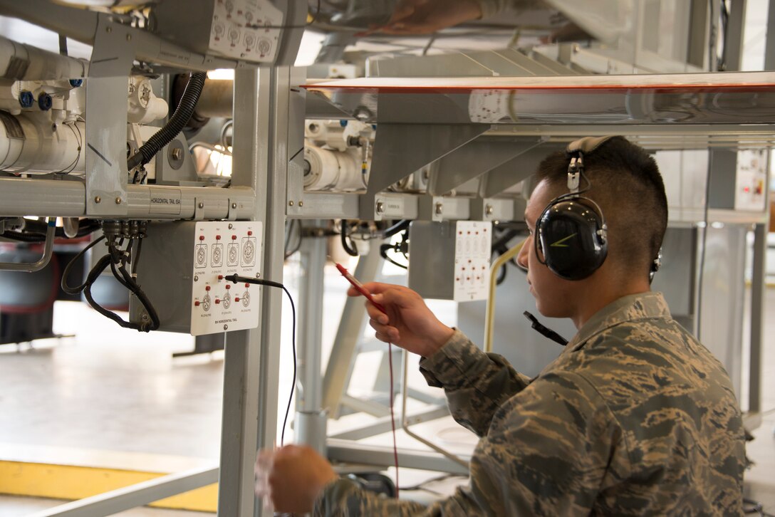 Airman Jaymond Marquez, student 364th Training Squadron, takes multimeter readings from the rear of a trainer aircraft during the hands-on training with a F-16 flight control simulator Oct. 8, 2015, at Sheppard Air Force Base, Texas. Hydraulic technicians practice how the different gears work in sync to move different flight controls anytime a part is changed in the field. (U.S. Air Force photo by Danny Webb)
