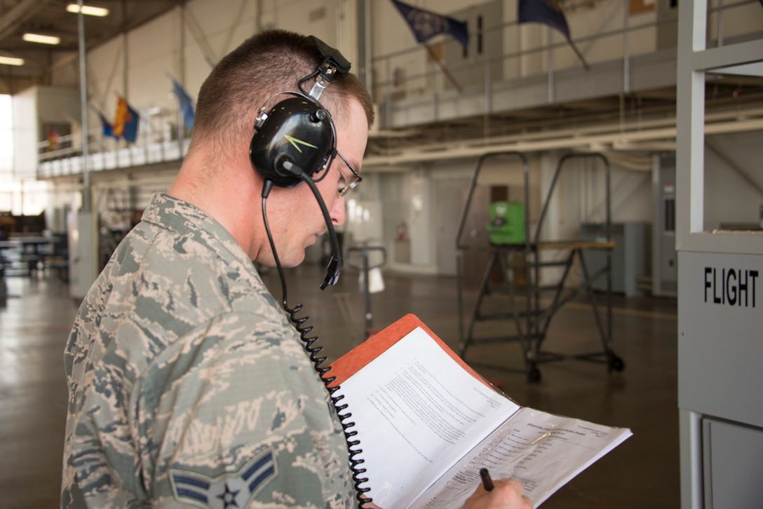 Airman 1st Class Krystian Zyszczynski, 364th Training Squadron hydraulic systems student, reviews the progress checklist during hands-on training with a F-16 flight control simulator Oct. 8, 2015, at Sheppard Air Force Base, Texas. Hydraulic technicians practice how the different gears work in sync to move different flight controls anytime a part is changed in the field. (U.S. Air Force photo by Danny Webb)
