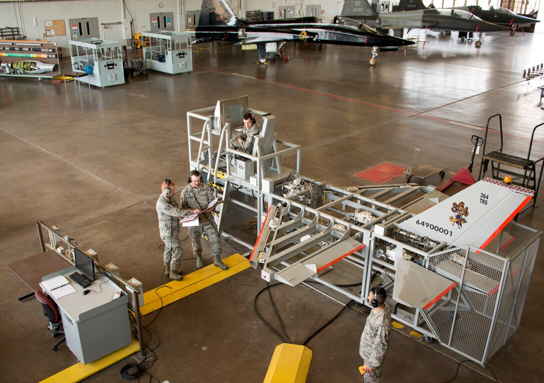 Staff Sgt. Daniel Cole, 364th Training Squadron hydraulics instructor,provides students hands-on experience with the F-16 flight control simulator Oct. 5, 2015. Hydraulic technicians practice how the different gearshifts work in sync to move the different flight sections anytime a part is changed in the field. (U.S. Air Force photo by Danny Webb)
