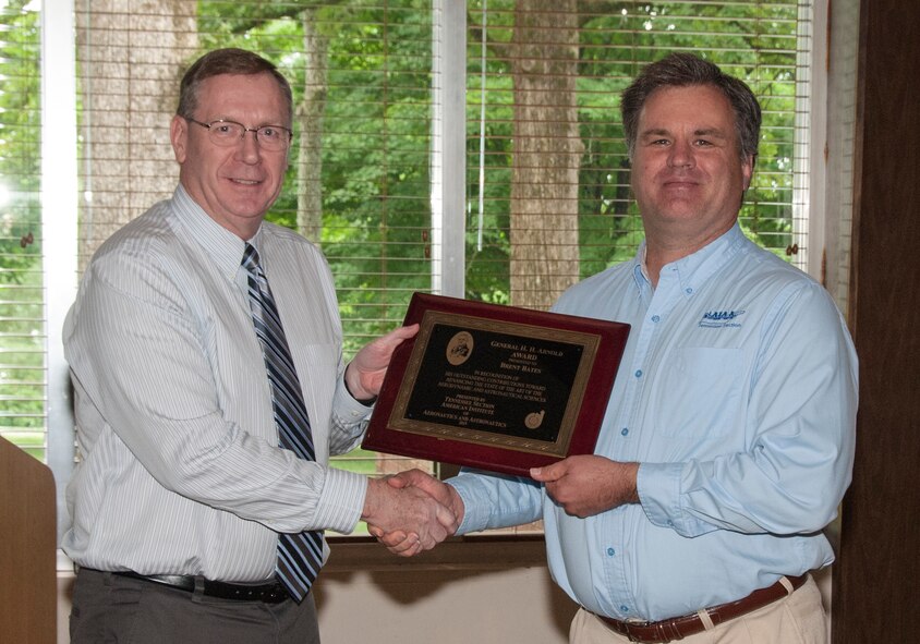 AEDC employee Brent Bates (left) receives an AIAA Tennessee Section Hap Arnold Award for his analyses of AEDC facilities from nominators and AEDC employees Dr. Joe Sheeley and Dr. Robert Hiers (not pictured).