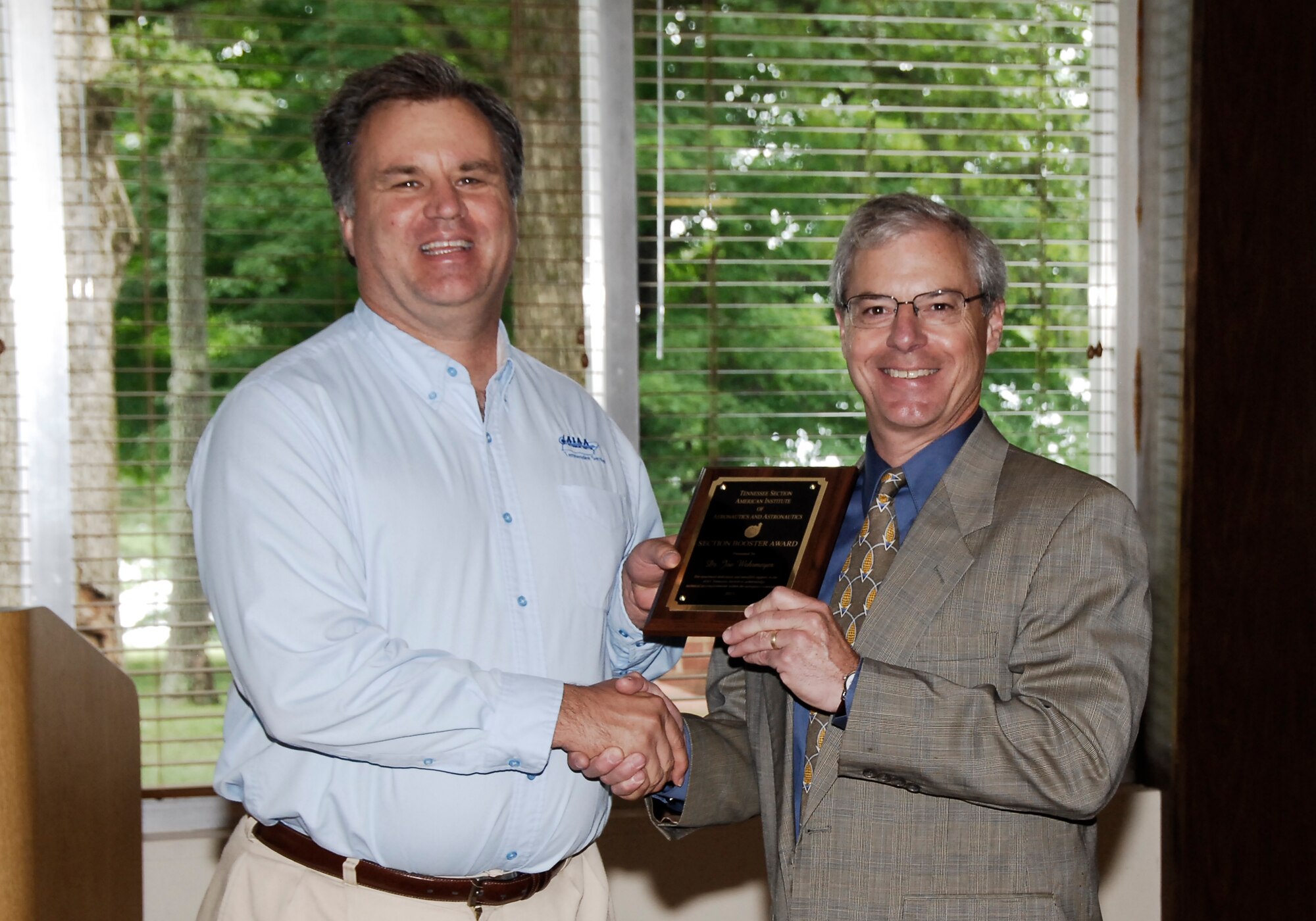 AEDC employee Dr. Joe Wehrmeyer (right) receives an AIAA Tennessee Section Booster Award for management of recent Section meetings from nominator and AEDC employee Dr. Joe Sheeley.