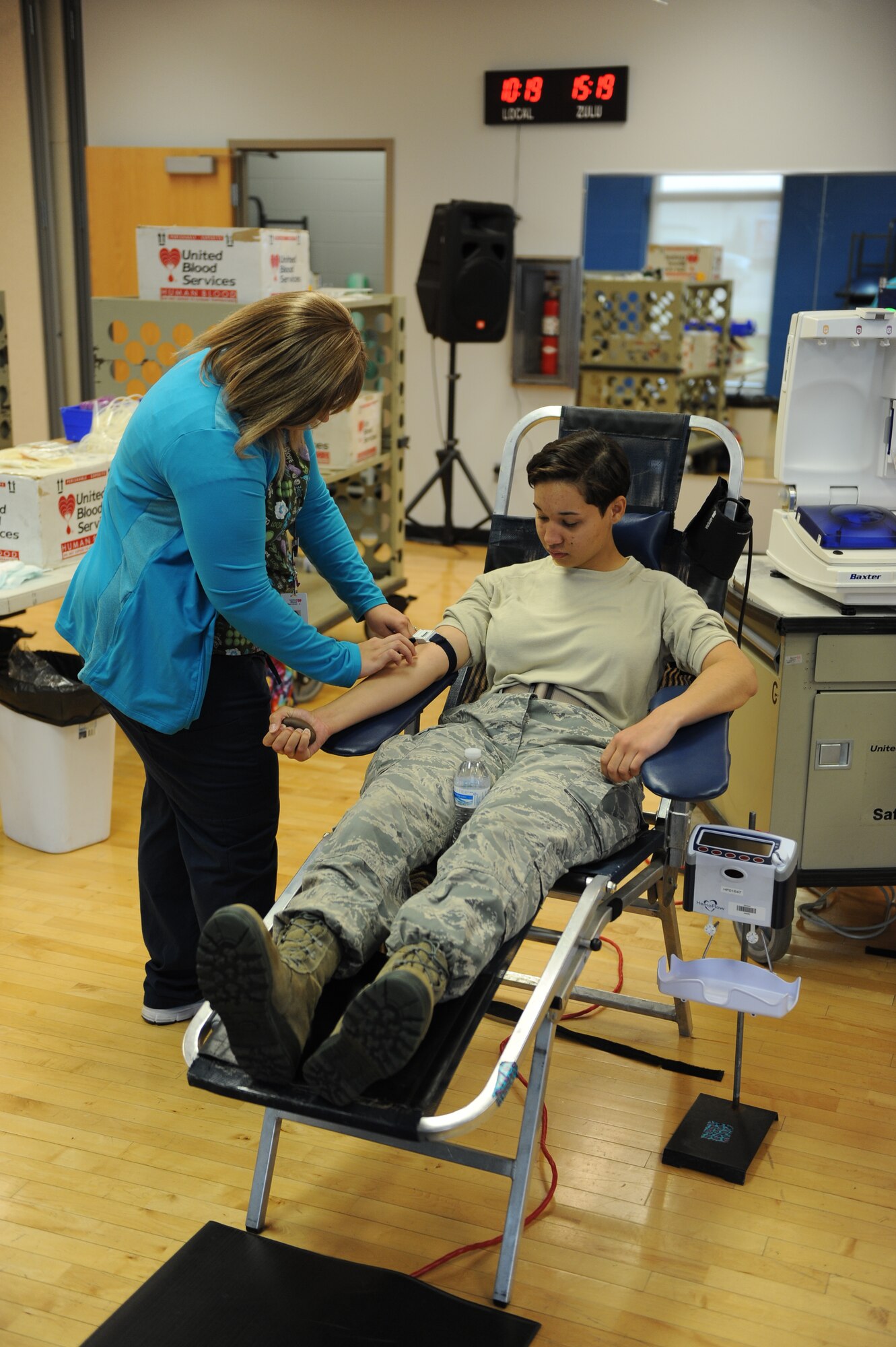 Airman Shania Adams, 5th Civil Engineer Squadron engineering technician donates blood during a blood drive held at the McAdoo Fitness Center at Minot Air Force Base, N.D., Oct. 9, 2015. Members from the base volunteered their time to donate blood in support of hospitals across N.D. (U.S. Air Force photo/Senior Airman Kristoffer Kaubisch)