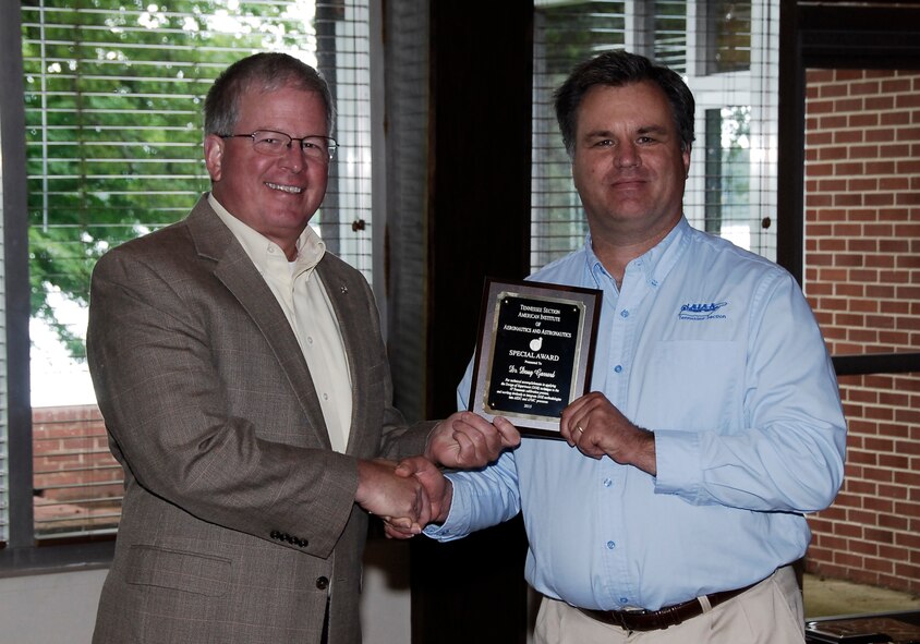 AEDC employee Dr. Doug Garrard (left) receives an AIAA Tennessee Section Special Award for the use of Design-of-Experiments in the Propulsion Wind Tunnel 4-foot Transonic tunnel calibration from nominator and AEDC employee Dr. Joe Sheeley.